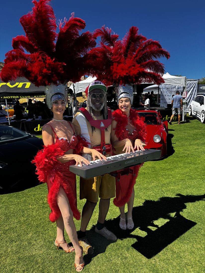 Musician carrying a keyboard with a Walkabout carrier alongside two event performers